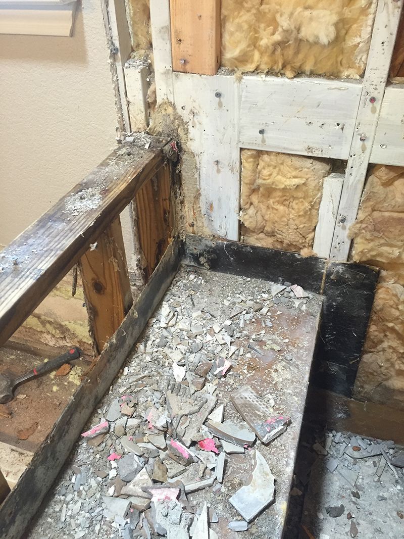 A piece of wood is sitting on the floor next to a wall.