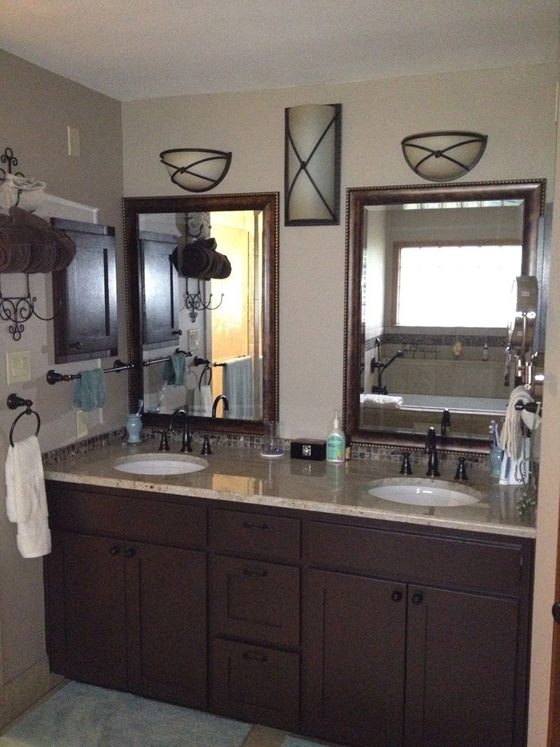 A bathroom with two sinks and two mirrors