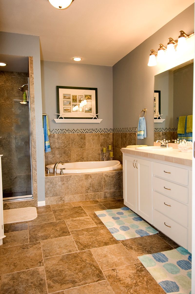 A bathroom with two sinks , a tub and a walk in shower.