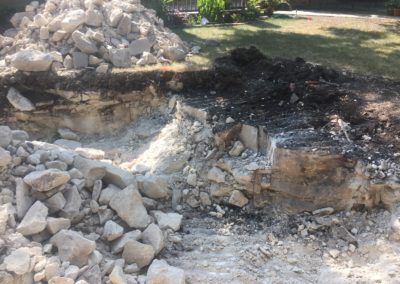 A pile of rocks is sitting on top of a pile of dirt.