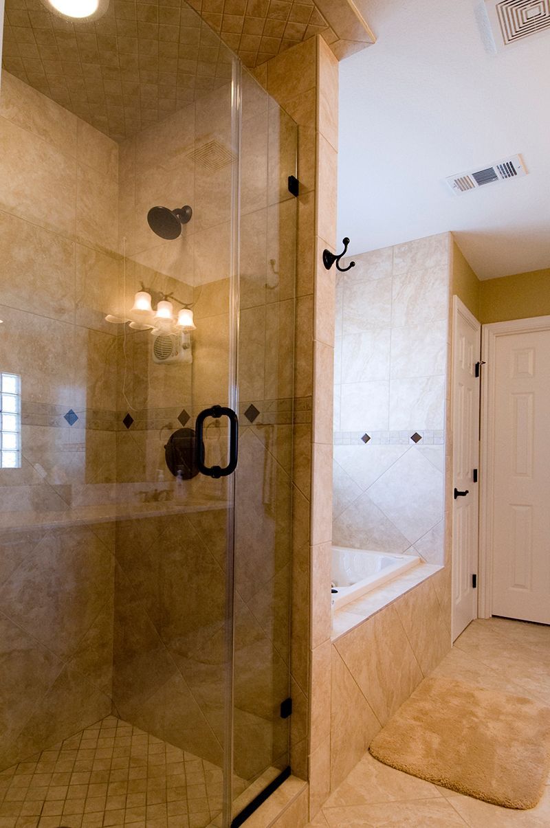A bathroom with a walk in shower and a bathtub