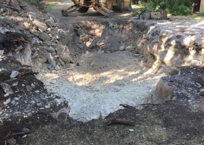 A bulldozer is digging a hole in the ground.