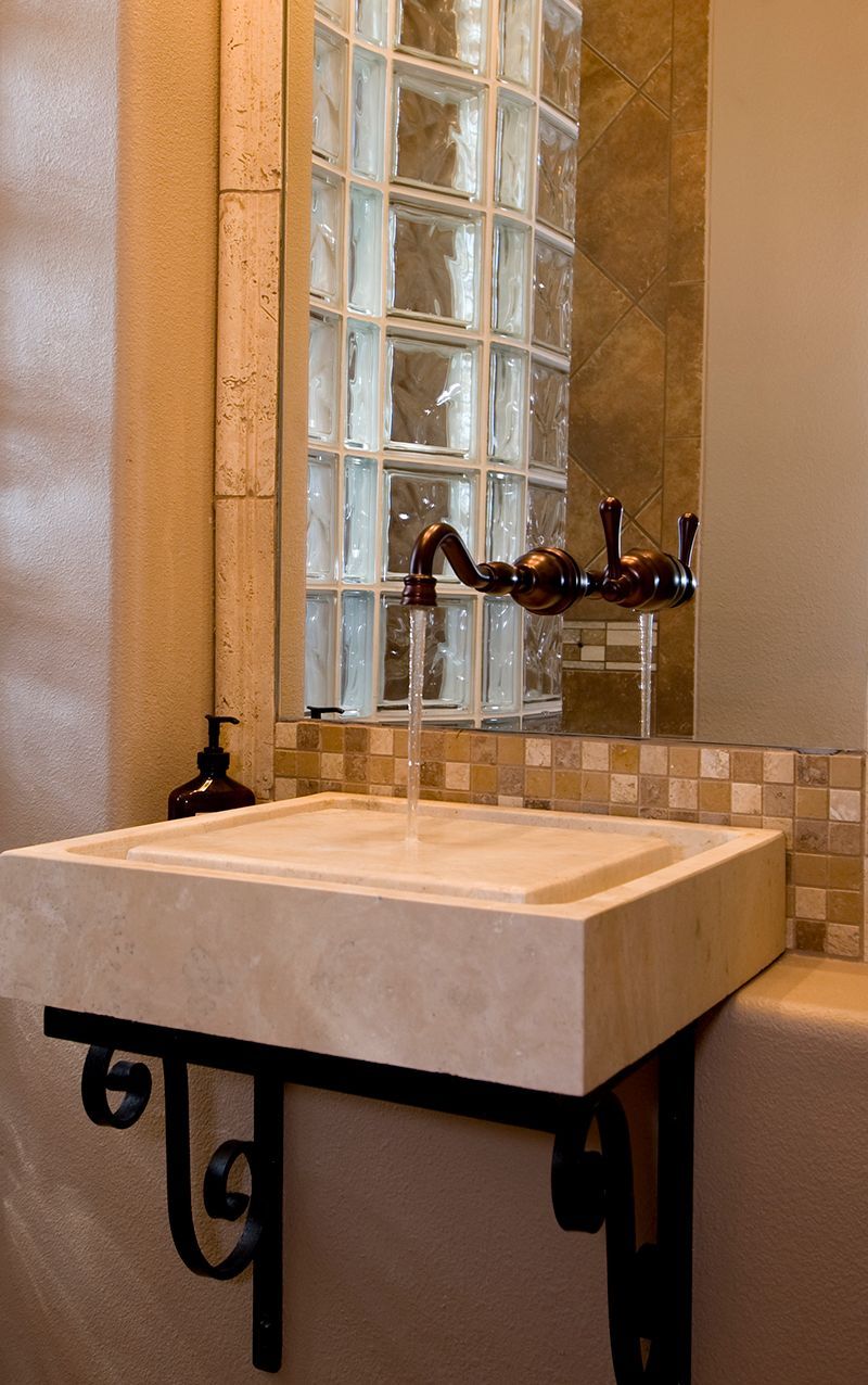 A bathroom sink with a faucet and a mirror