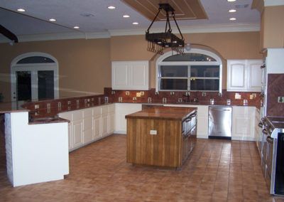 A kitchen with stainless steel appliances and a large wooden island