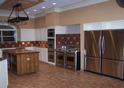 A kitchen with stainless steel appliances and a wooden island