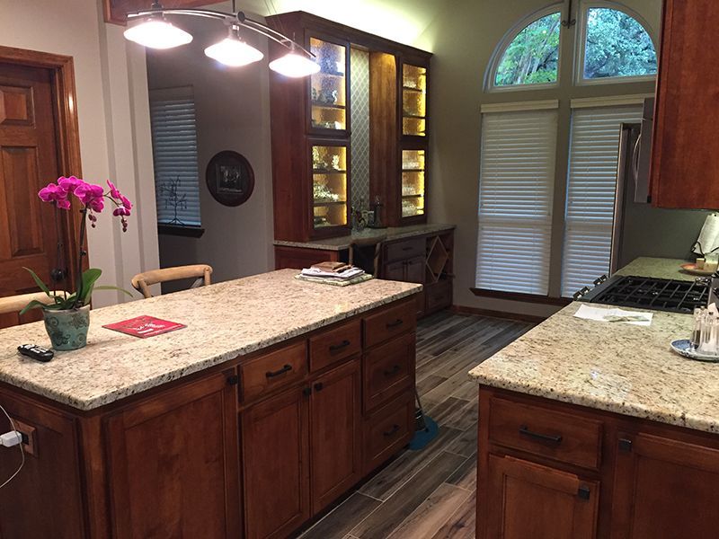 A kitchen with a large island and granite counter tops.