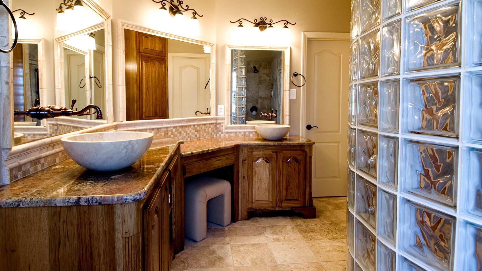 A red barn is behind a fence with a shade sail