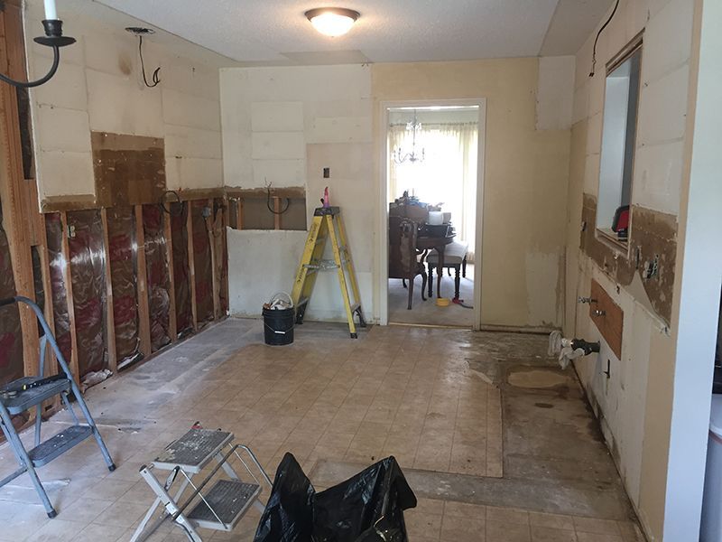 A room with a ladder and a chair in it.