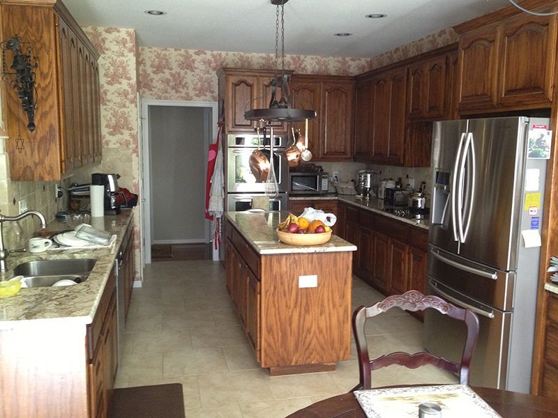 A kitchen with stainless steel appliances and wooden cabinets