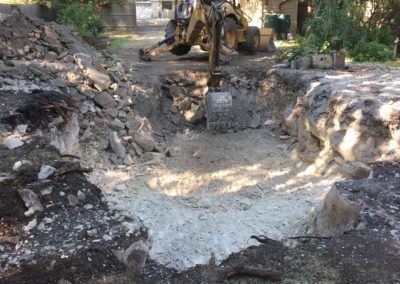A bulldozer is digging a hole in the ground.