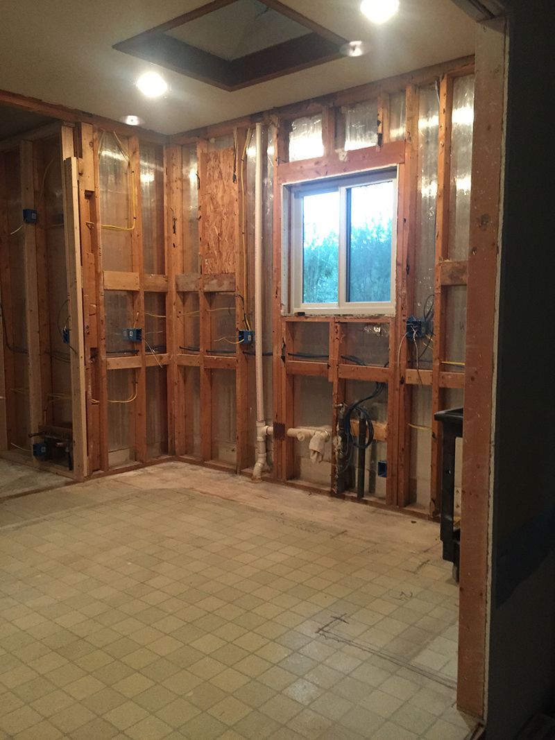 A room with wooden walls and a window in it.