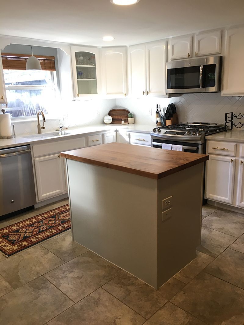 A kitchen with a large island in the middle of it.