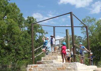 A group of people are playing on a ropes course.