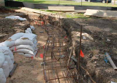 A construction site with a bunch of bags of sand in the dirt