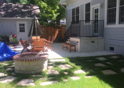 There is a fire pit in the backyard of a house.