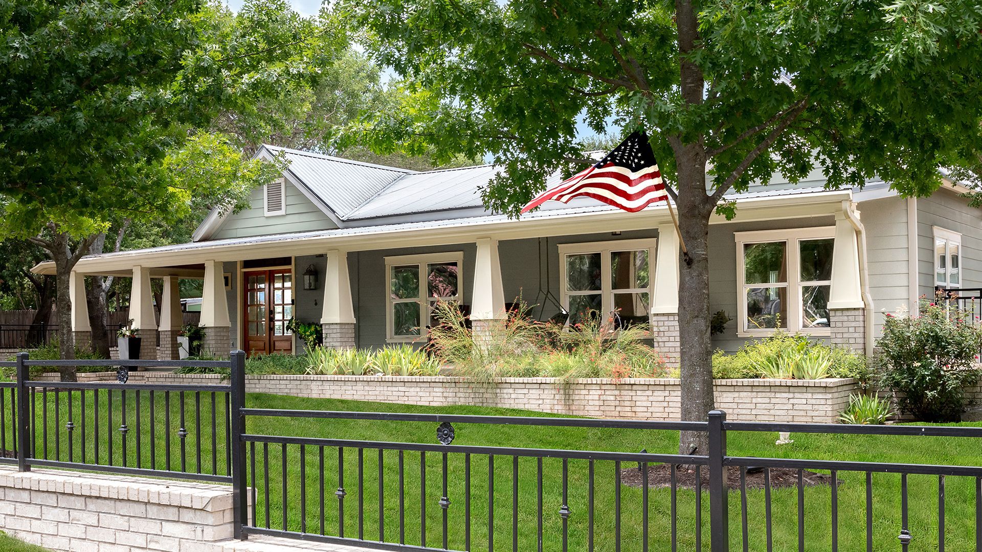 A kitchen with a large island and stools in it.