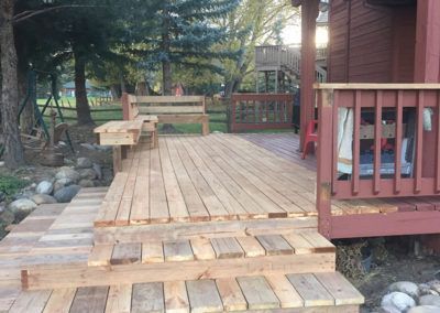 A wooden deck with stairs leading up to it