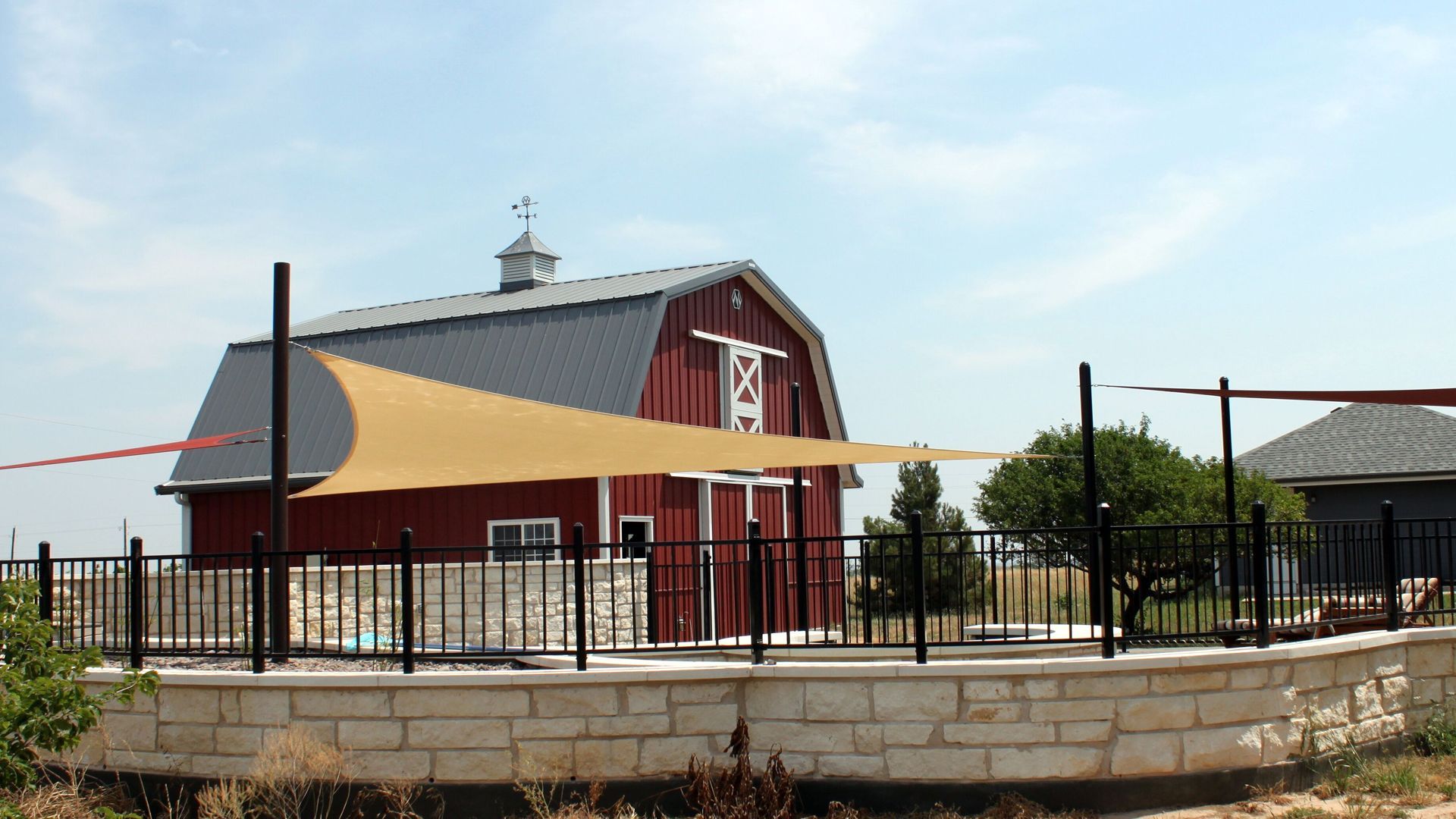 A kitchen with a large island and stools in it.