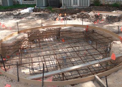 A pool is being built in the backyard of a house.