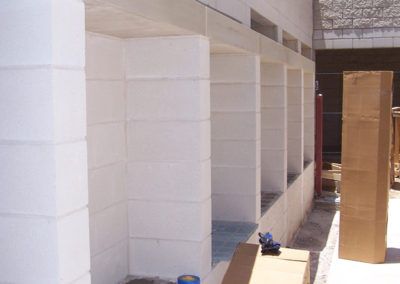 A building under construction with a lot of boxes on the ground