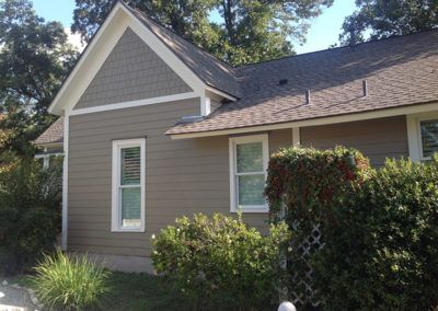 A house with a gray roof and white trim