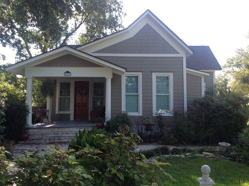 A house with a porch and a statue in front of it