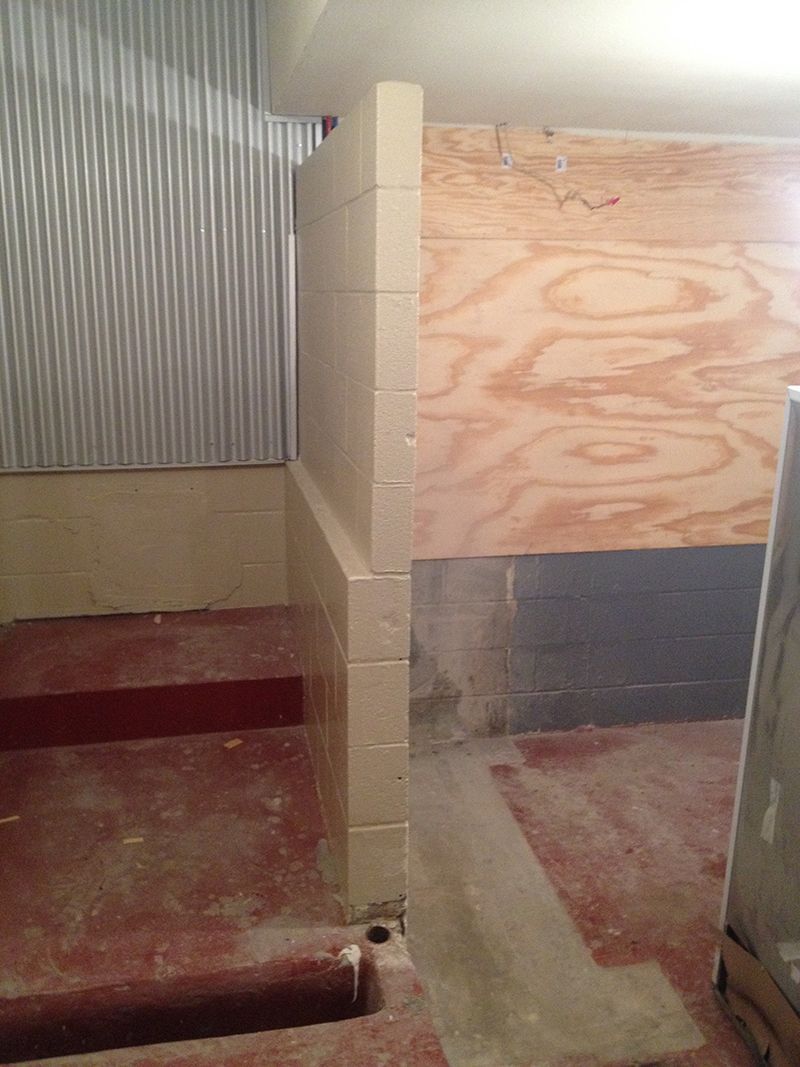 A room with a wooden wall and tiles on the floor.