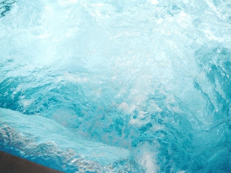 Turquoise ocean water splashing and foaming, viewed close up