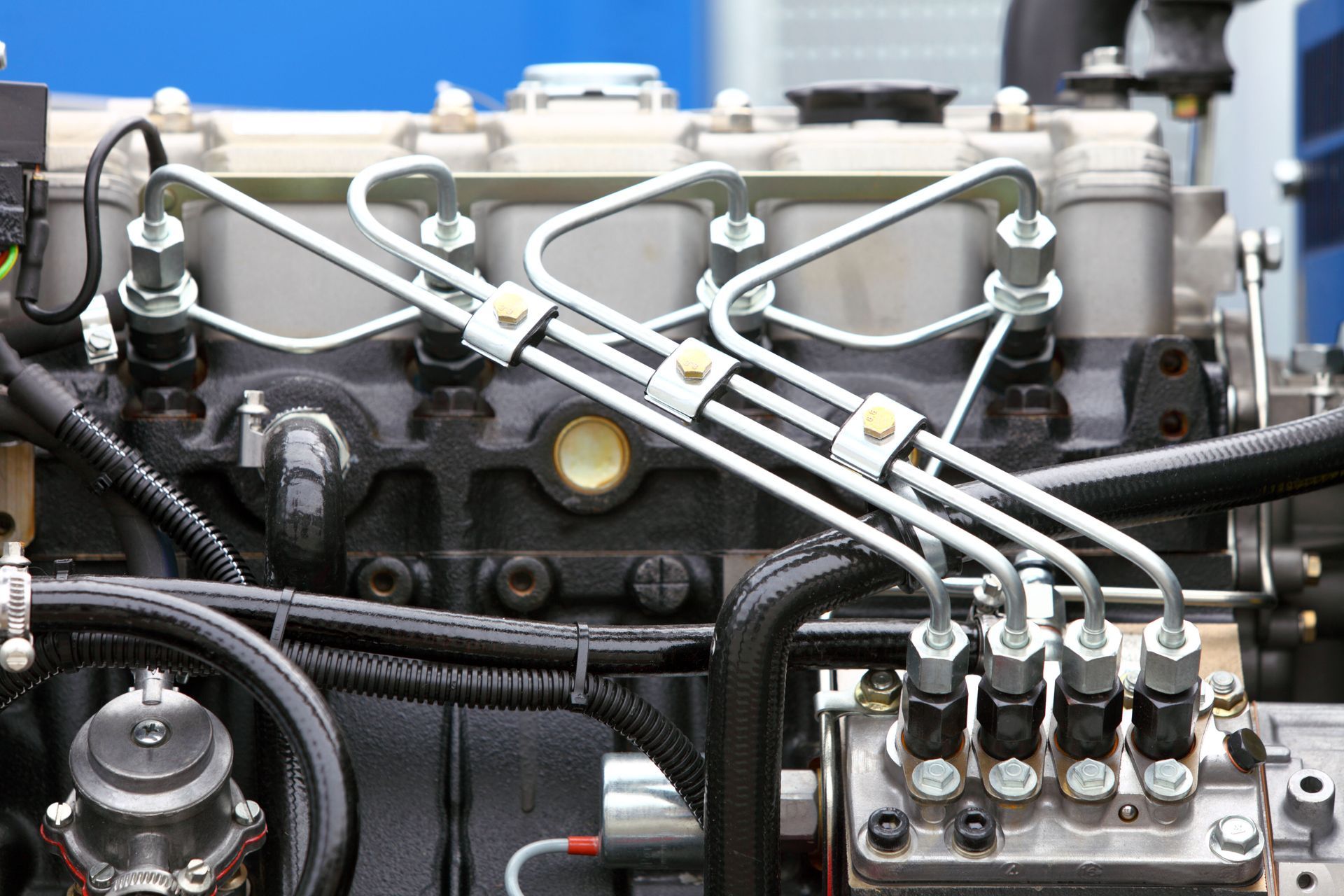 Close-up view of a mechanical diesel engine featuring high-pressure fuel lines connected to the fuel injection pump.