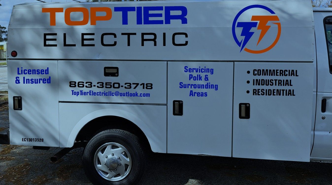 Side view of a white service van for Top Tier Electric, displaying contact info and areas served in blue and orange text.