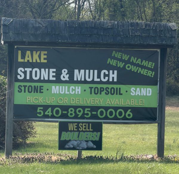 A sign for Lake Stone & Mulch with contact information, services, and a 