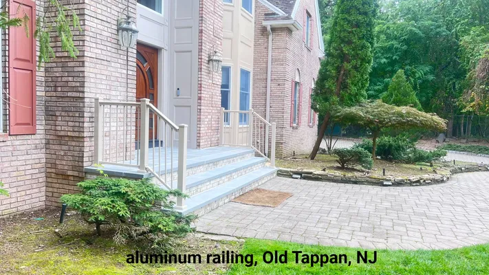 Aluminum railing on the front steps of a brick house in Old Tappan, NJ.