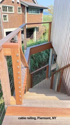 Wooden outdoor staircase with cable railing in Piermont, NY.