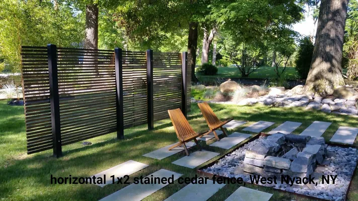Horizontal cedar fence in West Nyack, NY, with chairs and fire pit in a yard.