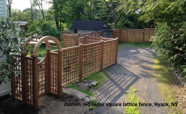 Red cedar lattice fence with arched gate in a yard, Nyack, NY.
