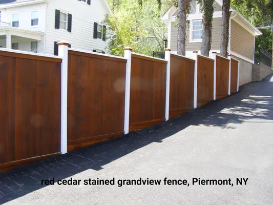 Red cedar stained grandview fence with white posts, in Piermont, NY.