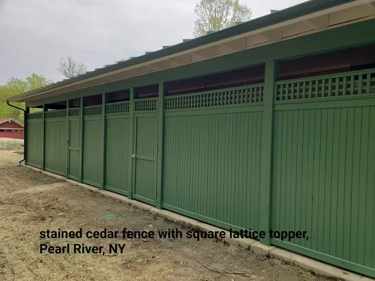 Green-stained cedar fence with square lattice topper, Pearl River, NY.