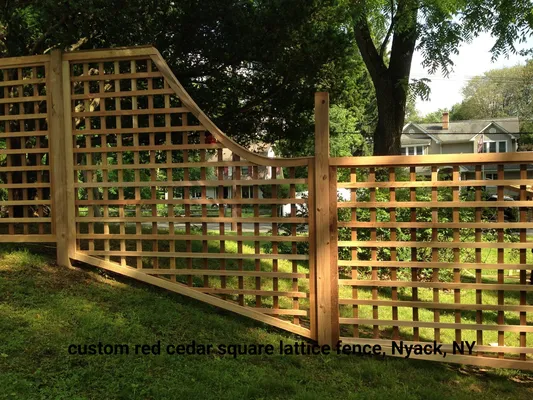 Red cedar lattice fence with gate in front yard.