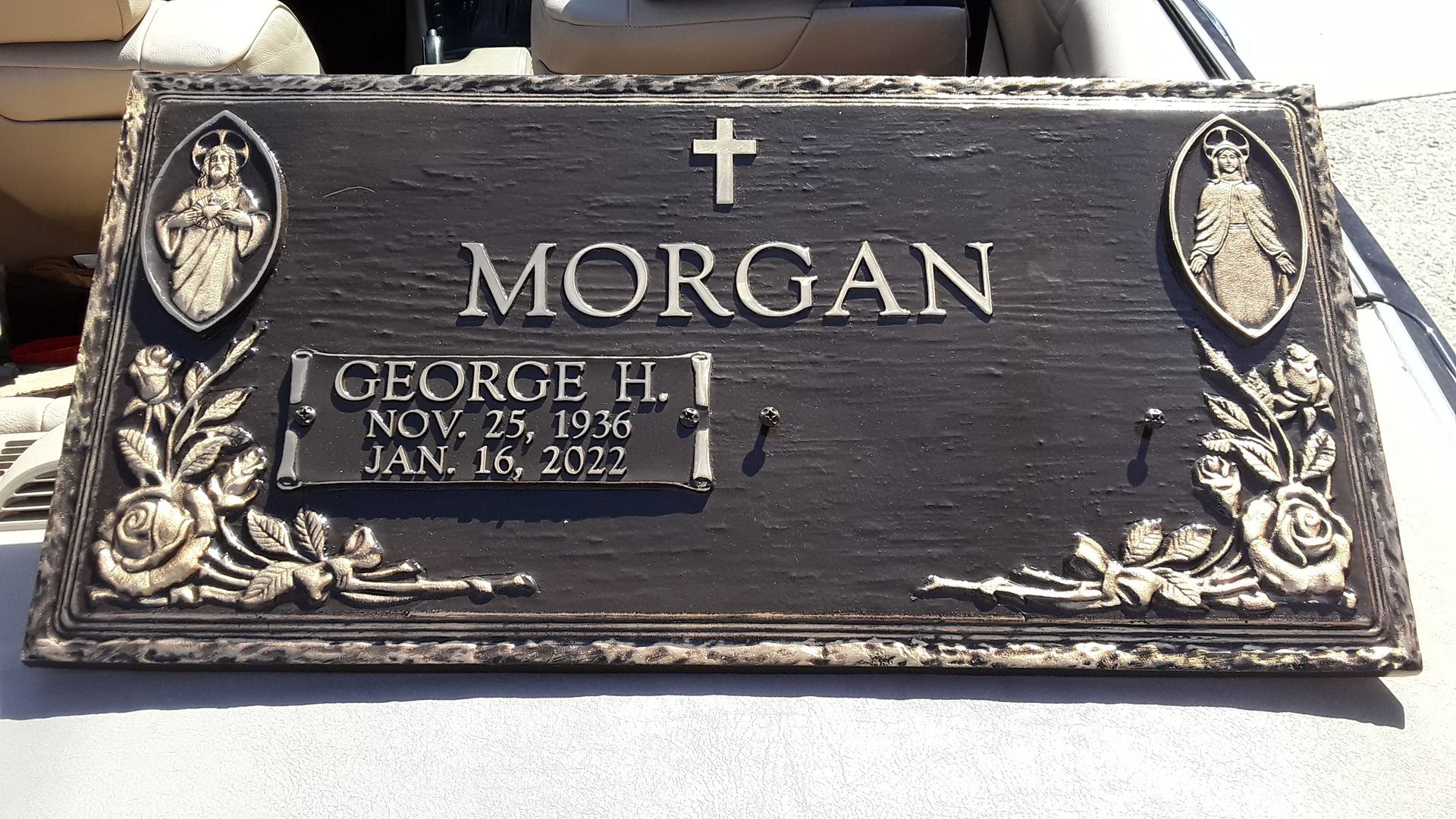 Bronze Marker with cross, laurel wreaths, and names Morgan and George H. in raised lettering