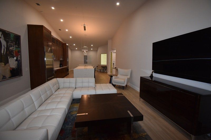 A living room with a white sectional couch and a coffee table