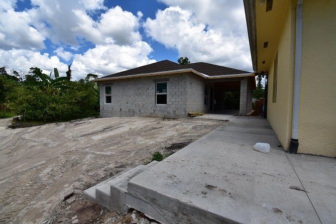 A house is being built in the middle of a dirt field.