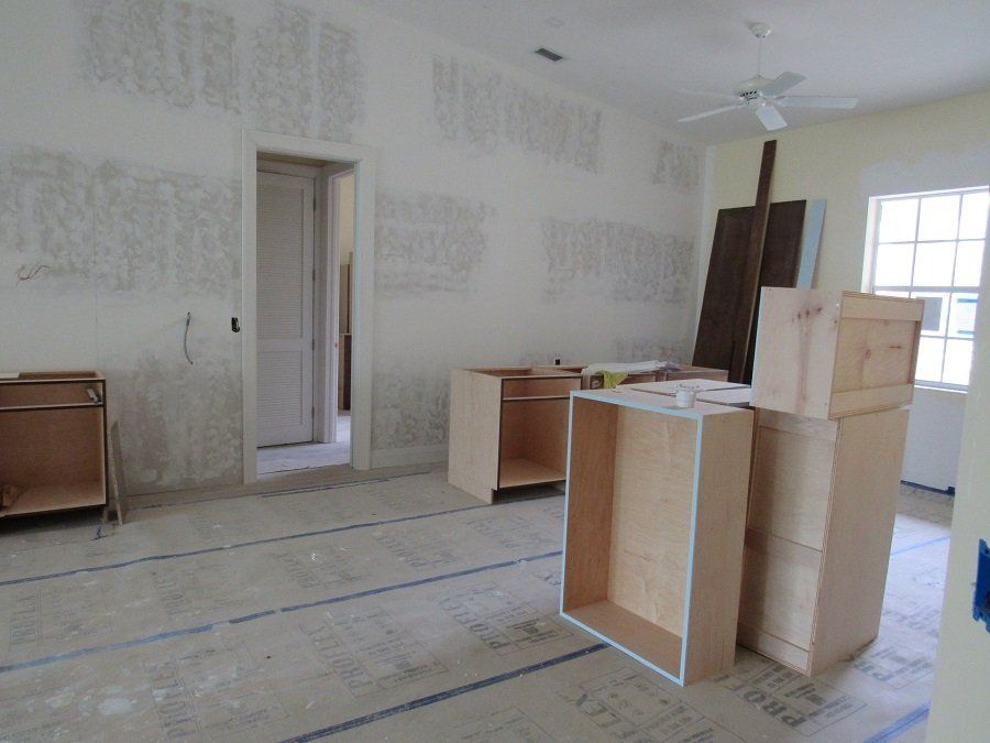 A room with a lot of wooden cabinets in it