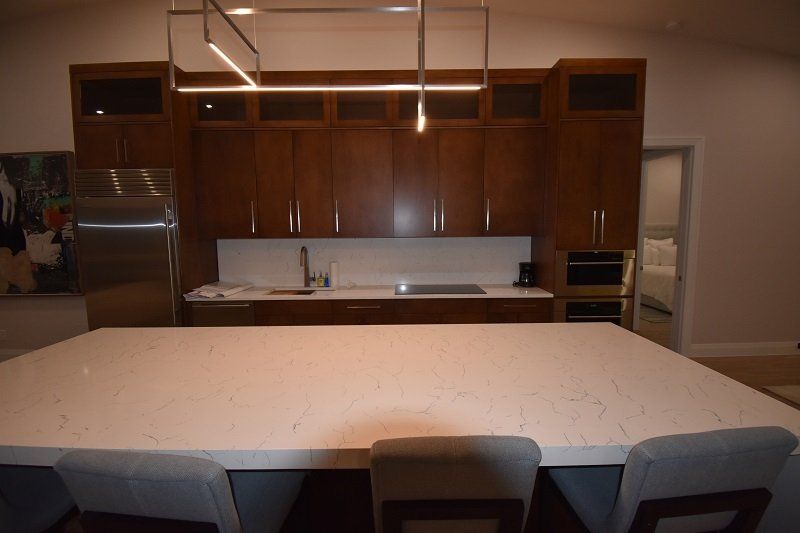 There is a large table in the middle of the kitchen.
