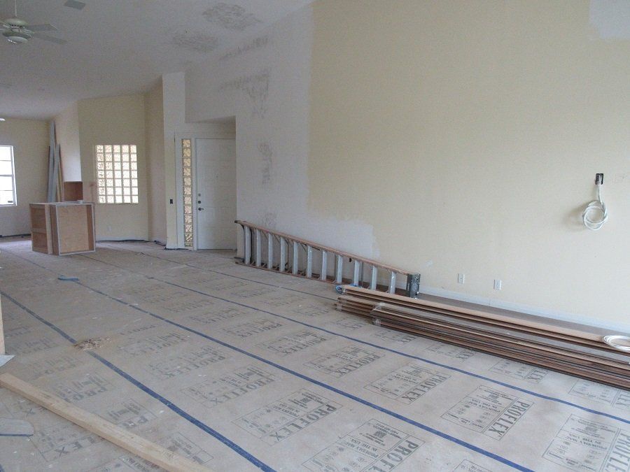 An empty room with a stack of wood on the floor