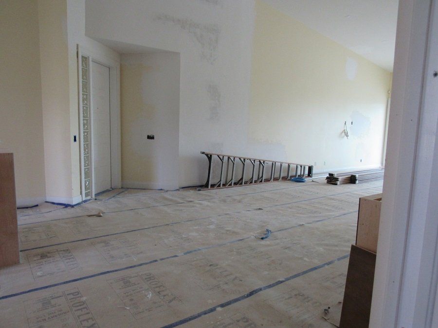 An empty room with a ladder on the floor