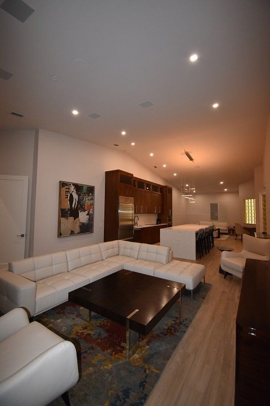 A living room with a large sectional couch and a coffee table