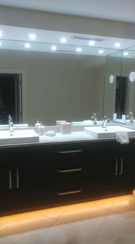A bathroom with two sinks and a large mirror.
