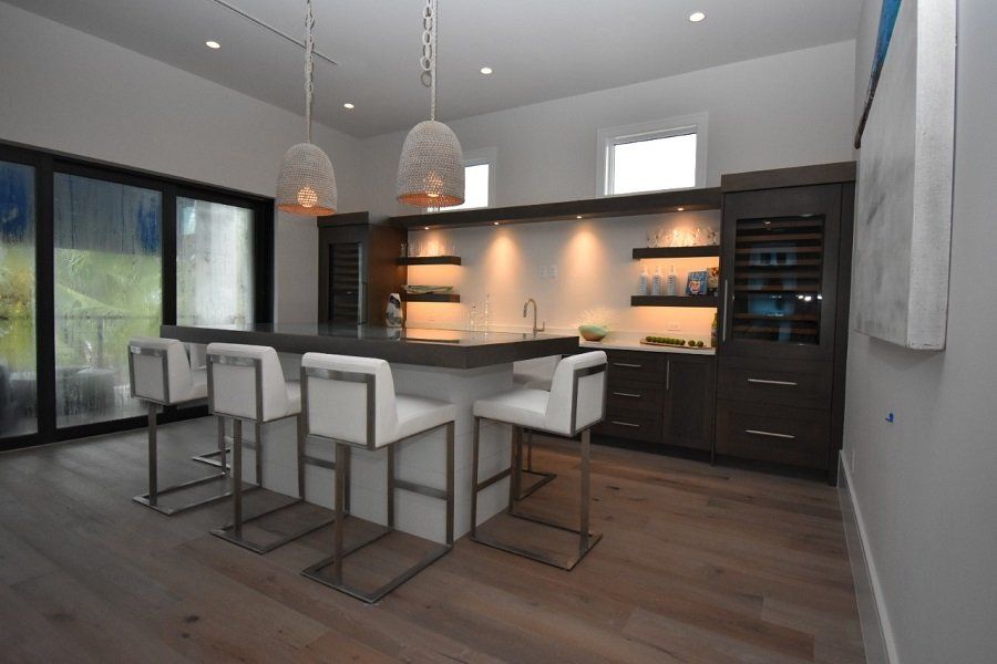 A kitchen with a large island and stools