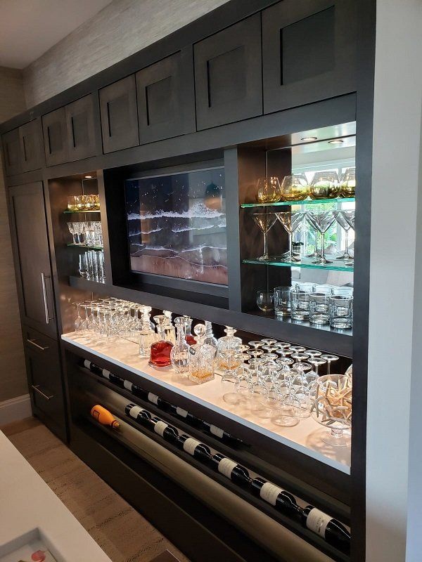 A bar with lots of wine glasses and bottles