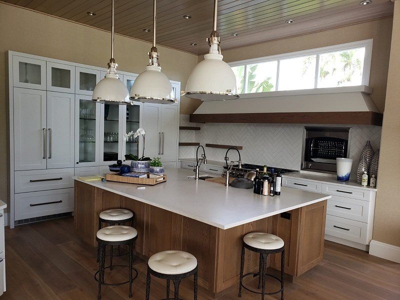 A kitchen with a large island and stools